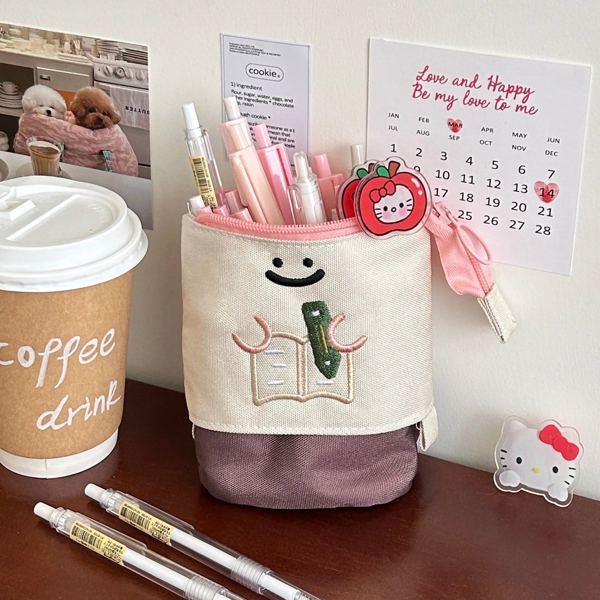 Brown Korean style cartoon print collapsible oxford fabric pencil case open on a table.