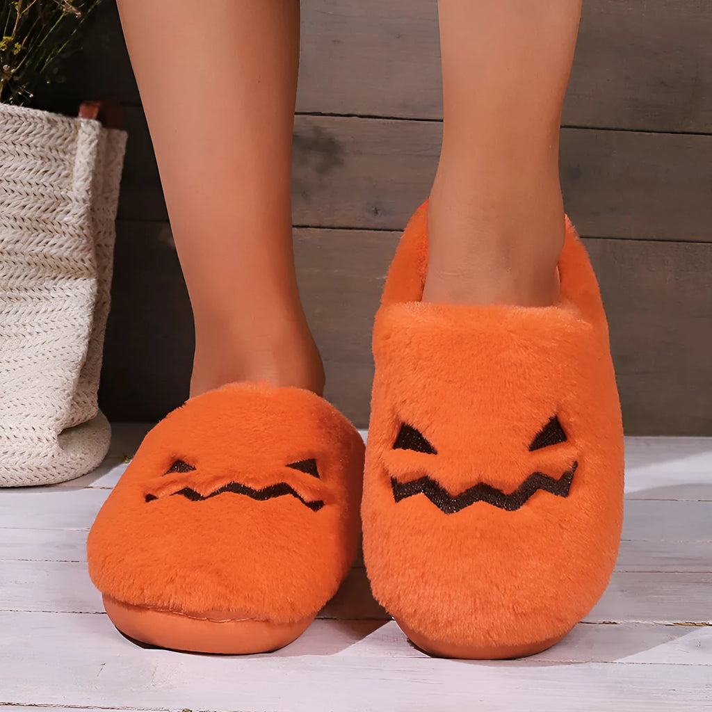 Orange Halloween pumpkin-themed plush indoor slippers with a non-slip PVC sole.