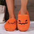 Orange Halloween pumpkin-themed plush indoor slippers with a non-slip PVC sole.