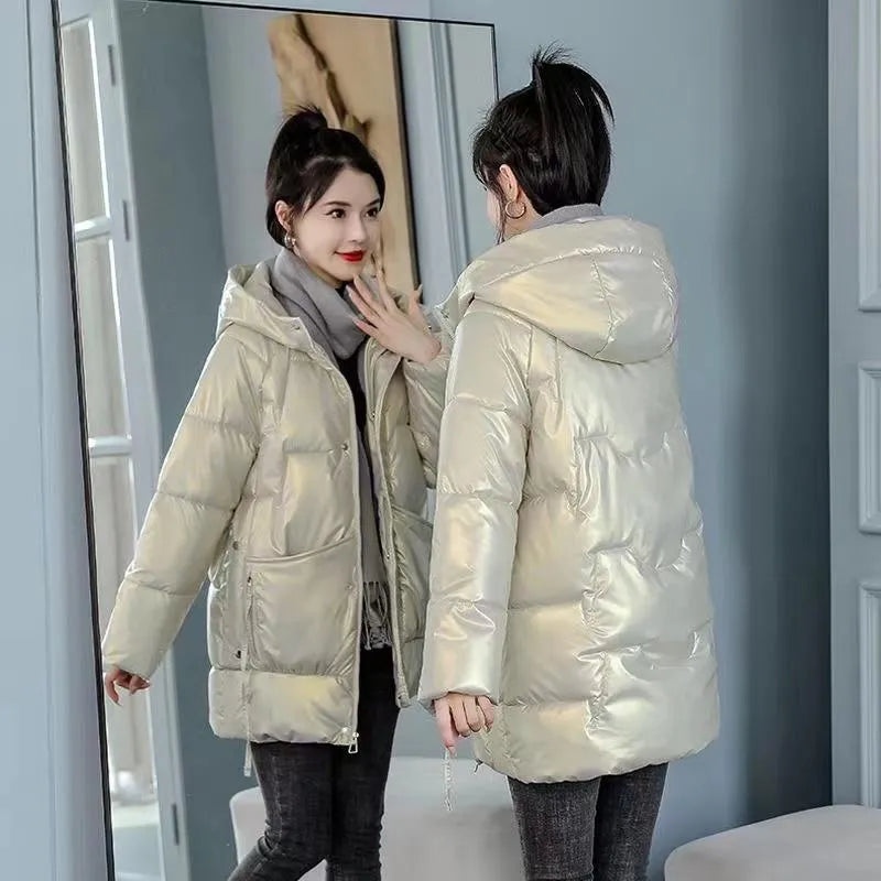 A woman's loose-fit hooded winter jacket in a poly-cotton blend, shown in a choice of colours including black and champagne.