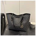 Large black PU leather shoulder bag with sewn thread detailing on a white background.