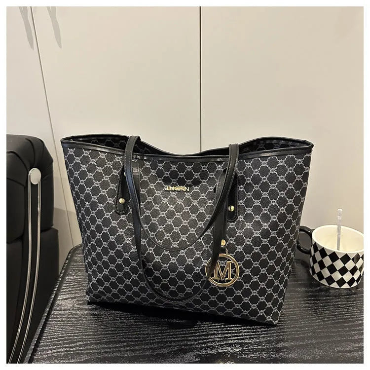 Large black PU leather shoulder bag with sewn thread detailing on a white background.