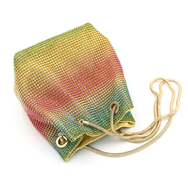 Rainbow coloured rhinestone bucket bag with soft structure and open top, showing sparkling texture.
