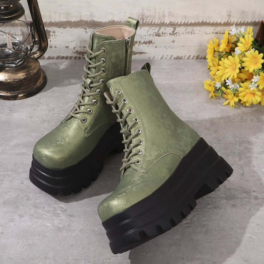 Women's black retro platform Martin boots with patchwork detail and side zipper.