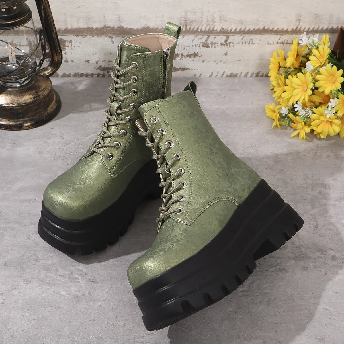 Women's black retro platform Martin boots with patchwork detail and side zipper.
