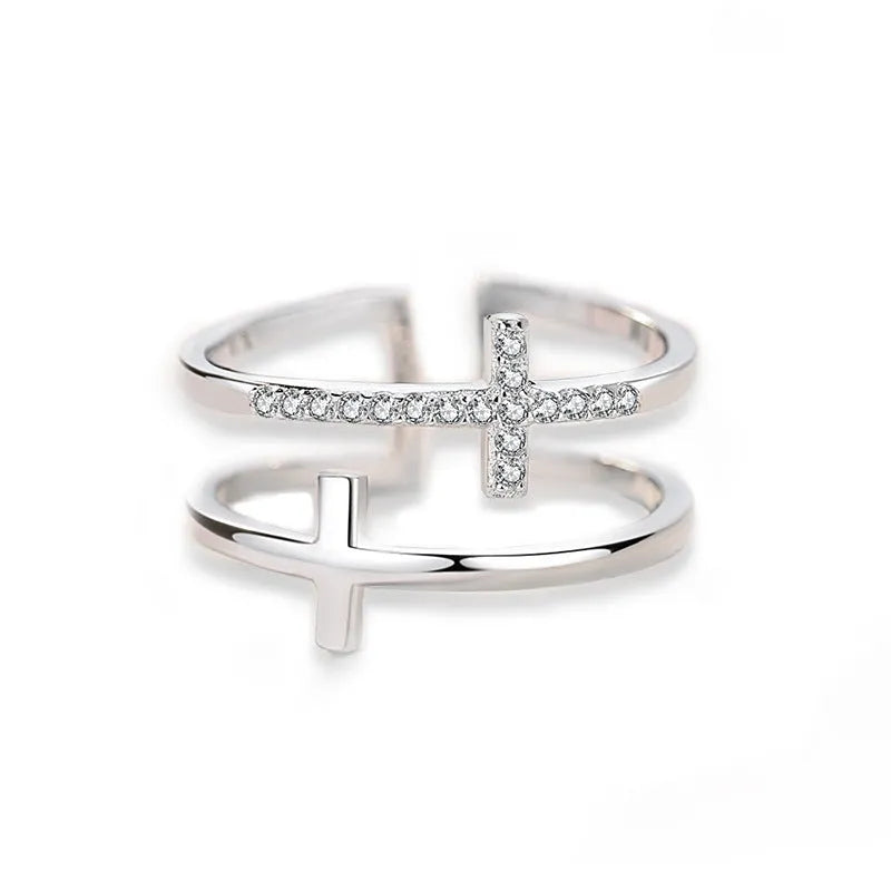 Women's adjustable copper ring with double cross design and white zircon stone in sterling silver inlay.
