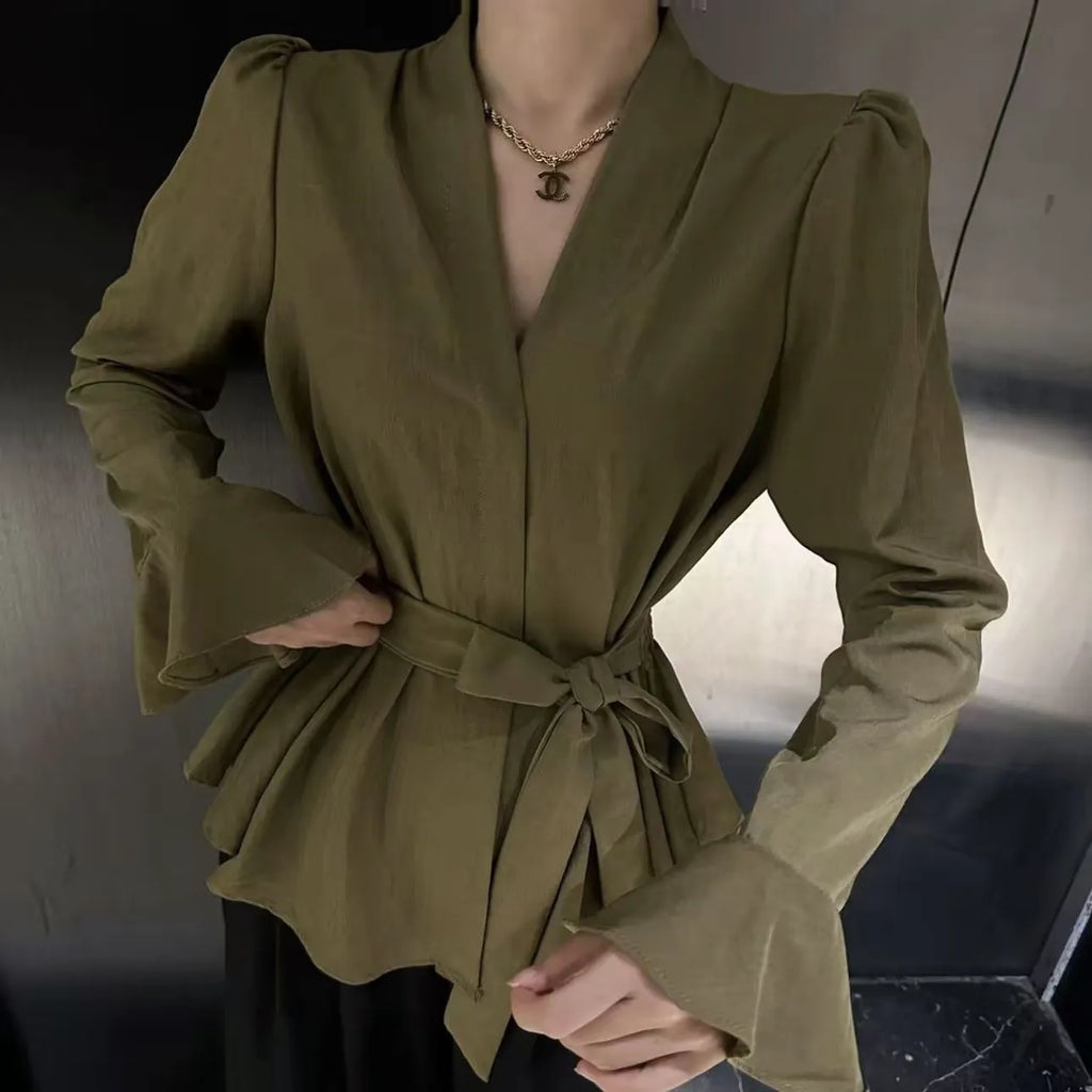 Women's black French-style long sleeve shirt with irregular collar, bell sleeves, and a tied front.