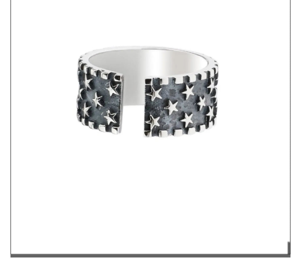 Adjustable sterling silver ring with a geometric pattern of five-pointed stars on the band.