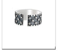 Adjustable sterling silver ring with a geometric pattern of five-pointed stars on the band.