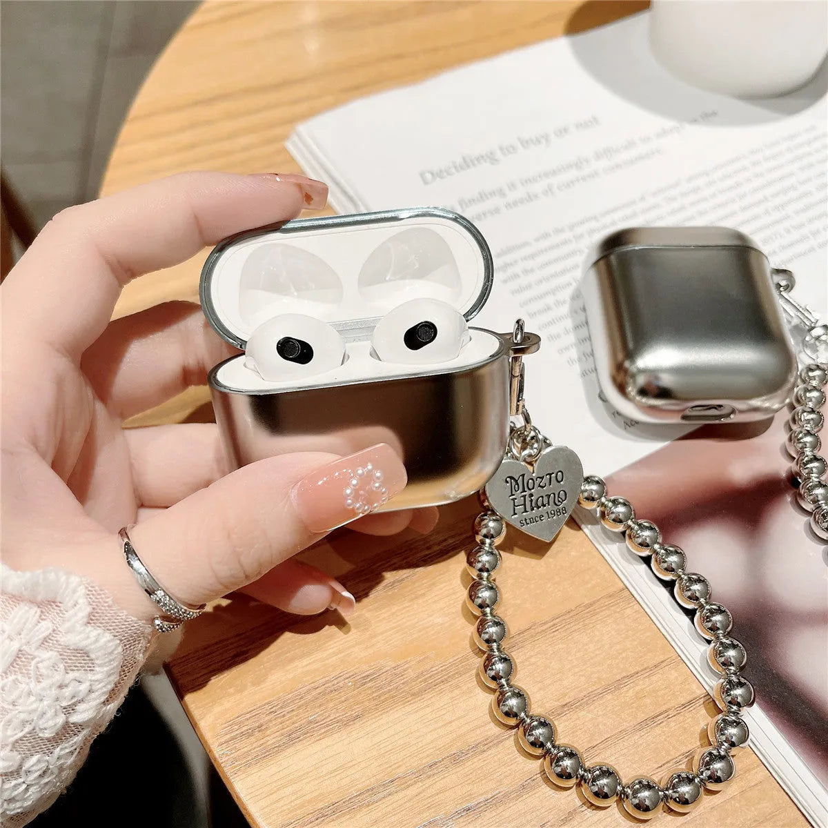 Matte plating colour TPU protective case for AirPods with an attached carrying bracelet.