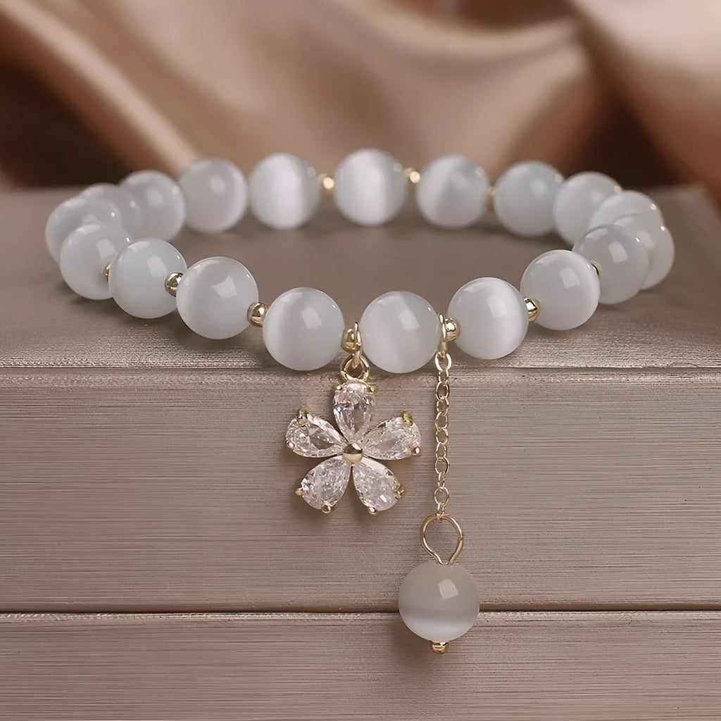 Women's white Cat's Eye crystal bracelet with flower tassel pendant and safety buckle closure