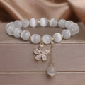 Women's white Cat's Eye crystal bracelet with flower tassel pendant and safety buckle closure