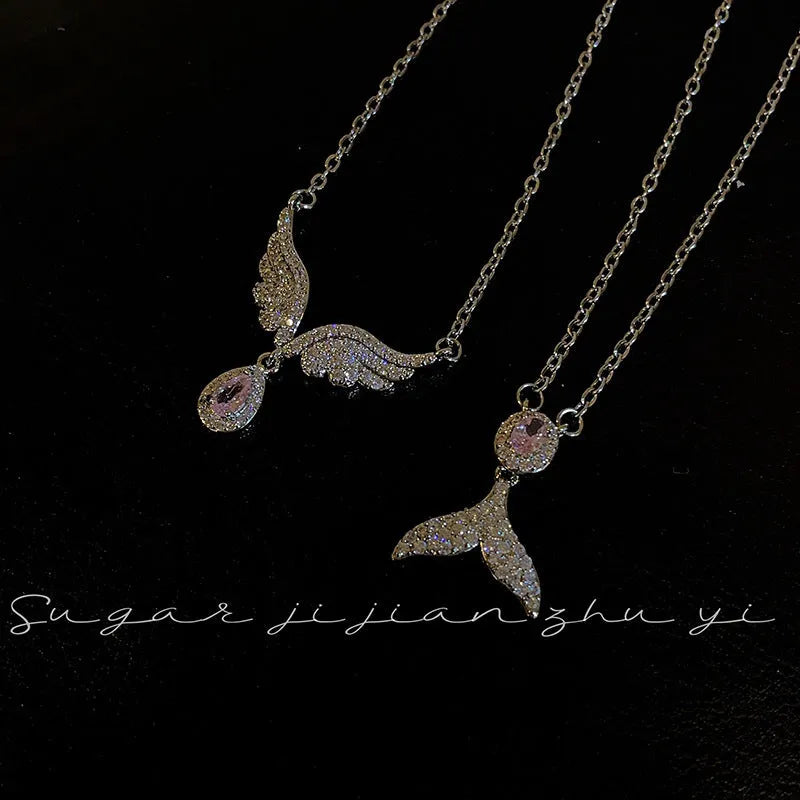 Simple sterling silver necklace with a geometric fishtail or angel wing pendant on an O-ring chain.