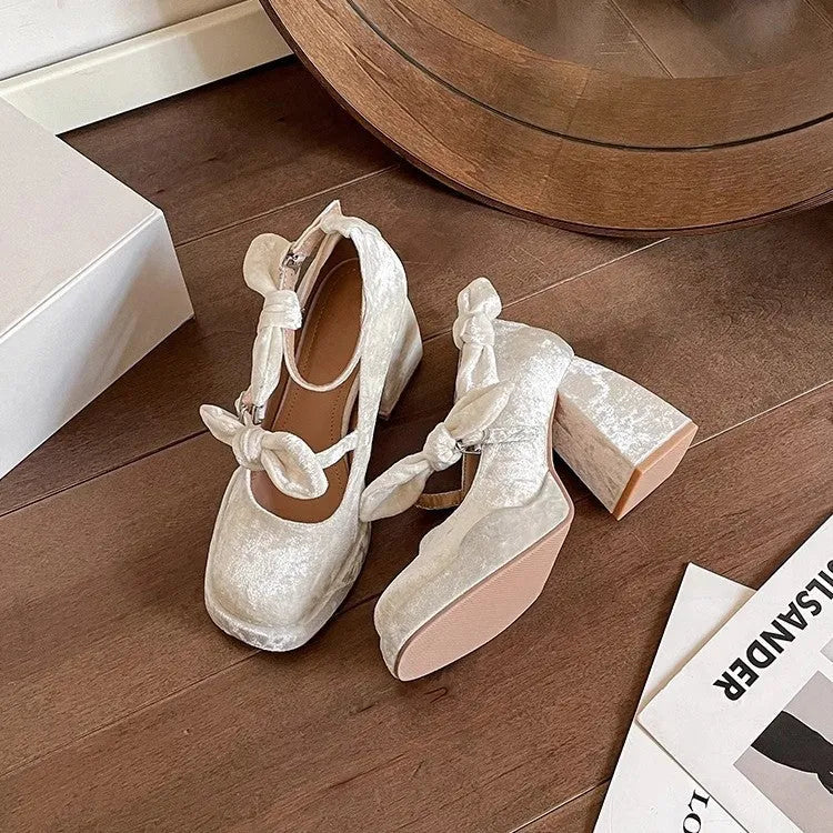 Apricot chunky heel waterproof platform pumps with bow detail, square toe, and buckle fastening on a plain background