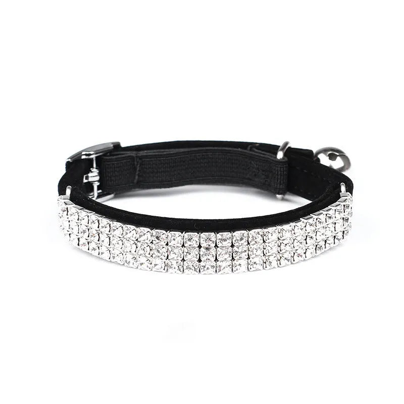Red velvet cat collar with a line of sparkling rhinestones, showing the adjustable buckle.