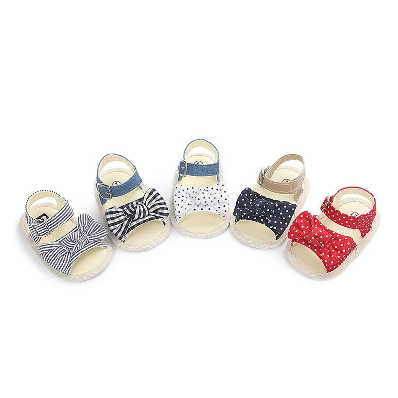 White and black velcro baby shoes showing adjustable straps and low-cut design for toddlers