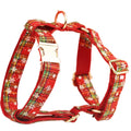 Four-piece Christmas pet accessory set with red snowflake collar, plaid leash, festive vest, and bow tie