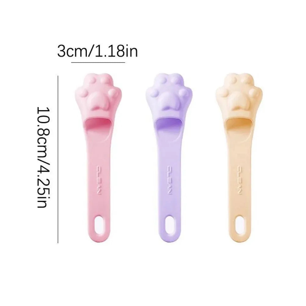 Silicone finger toothbrush for pets in pink, purple, and yellow colours