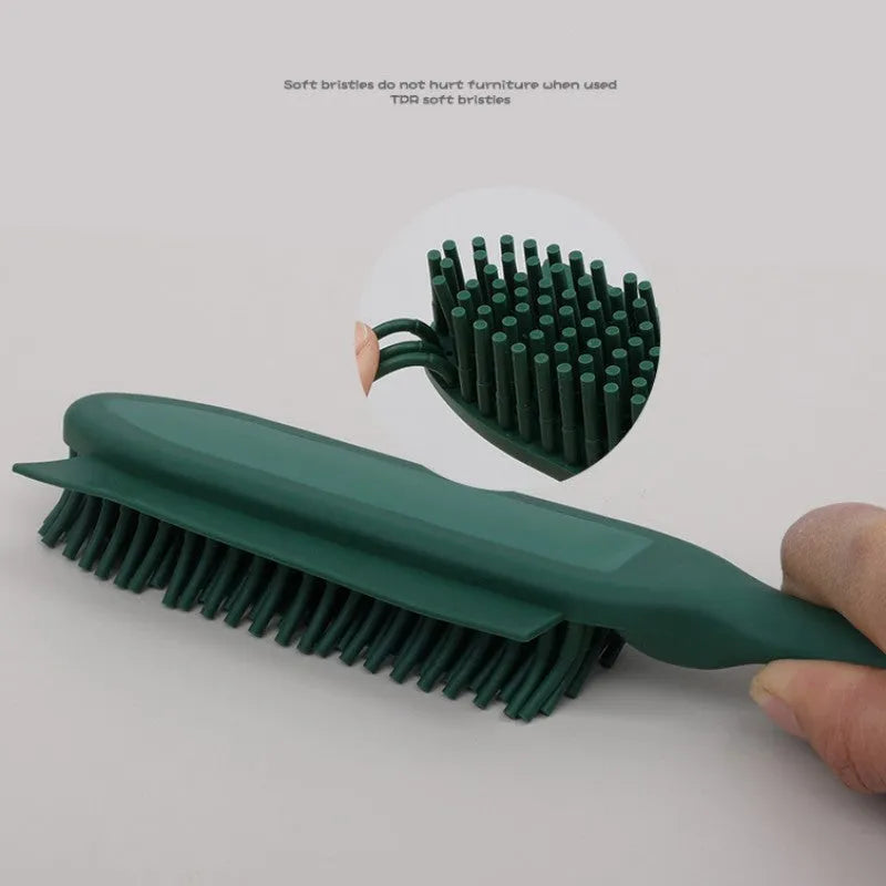 Green silicone pet hair remover brush with plastic handle on a fabric sofa