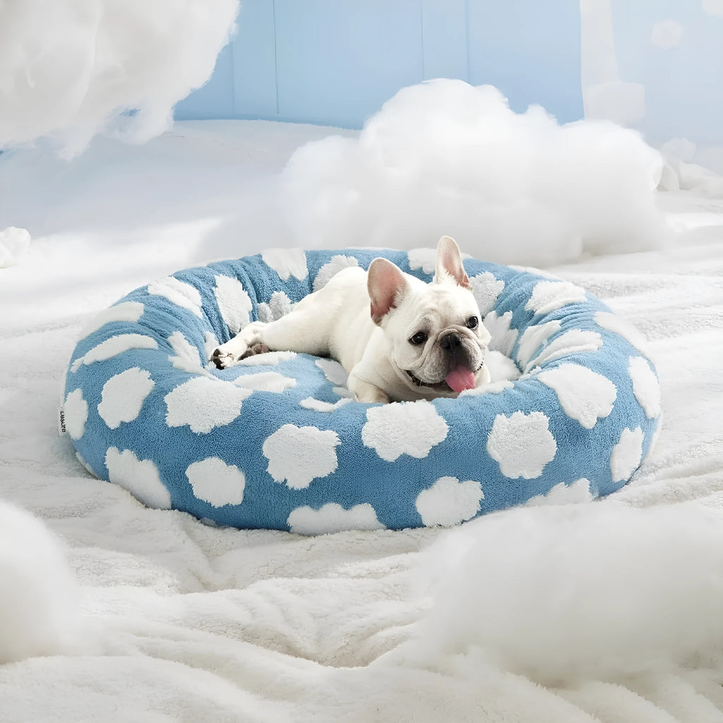 Round plaid dog bed with a raised edge on a plastic base, shown in a sea blue and white colour.
