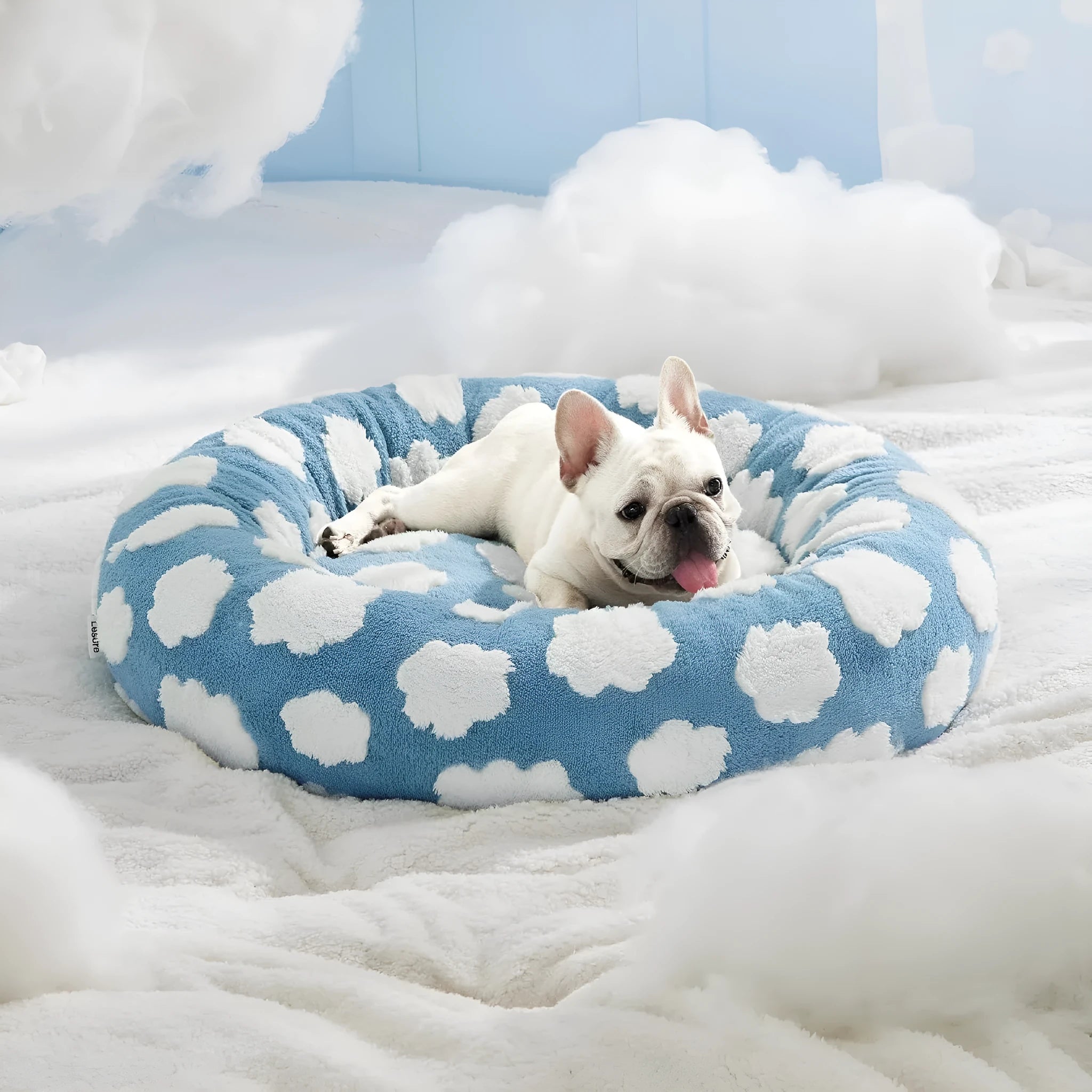 Round plaid dog bed with a raised edge on a plastic base, shown in a sea blue and white colour.