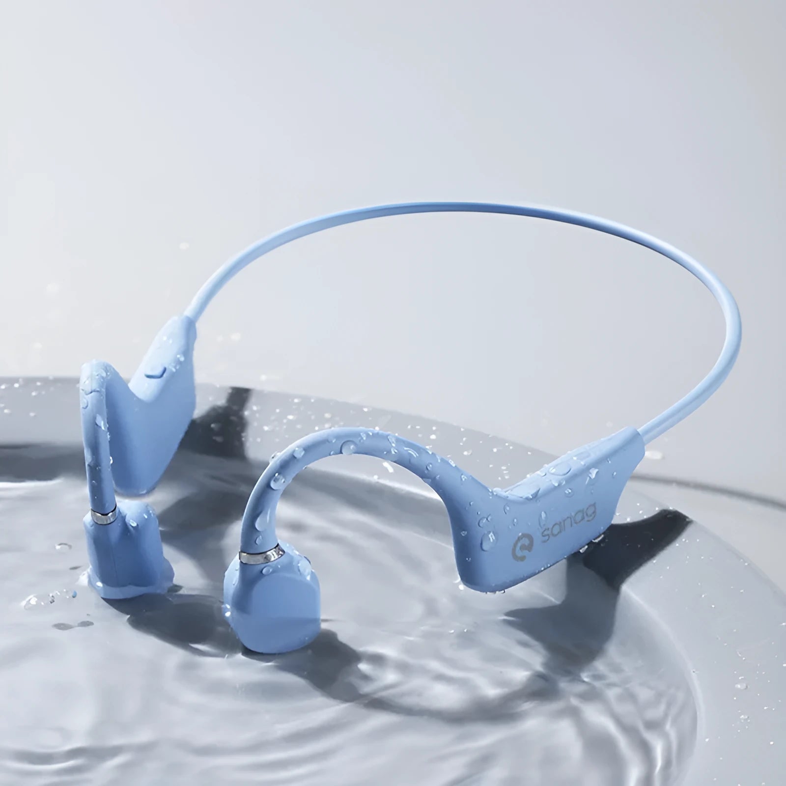 Bone conduction Bluetooth sports headset hanging around a neck, shown in multiple colour options.