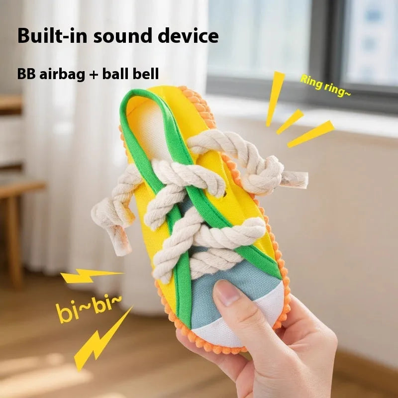 Slipper-shaped plastic dog chew toy with a squeaker, shown in yellow, black, and blue colour options.