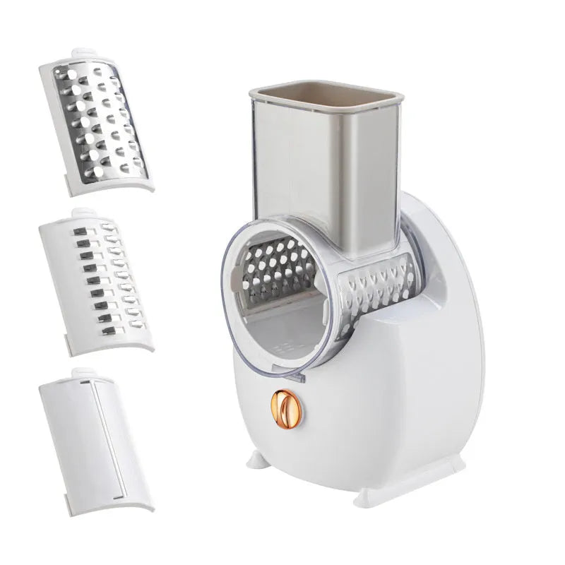 White electric rotary vegetable slicer with suction base and interchangeable blades on a kitchen counter.