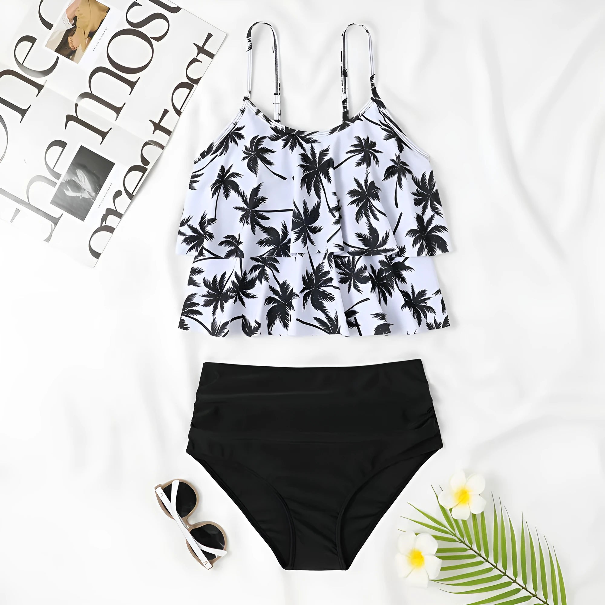 Black high-waisted double-layer swimsuit briefs and sleeveless top laid flat, with a coconut tree print variation.