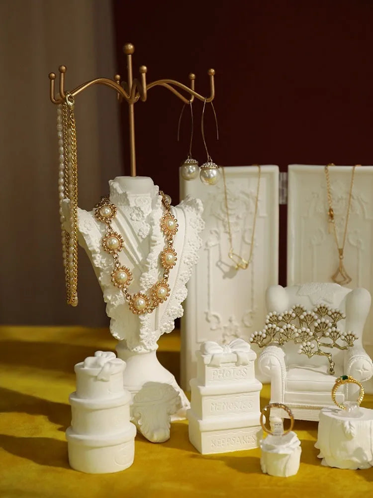 White plaster retro jewellery display stand with three layers, neutral background for necklace display