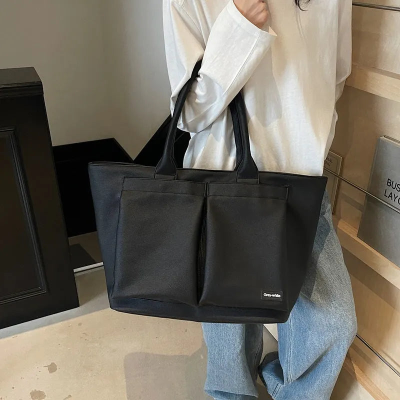Lightweight expandable PU shoulder bag shown in solid green colour with ventilation panel