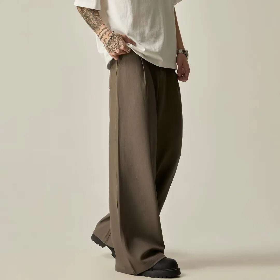 Men's black wide-leg straight-leg casual trousers made from a cotton-polyester blend fabric.