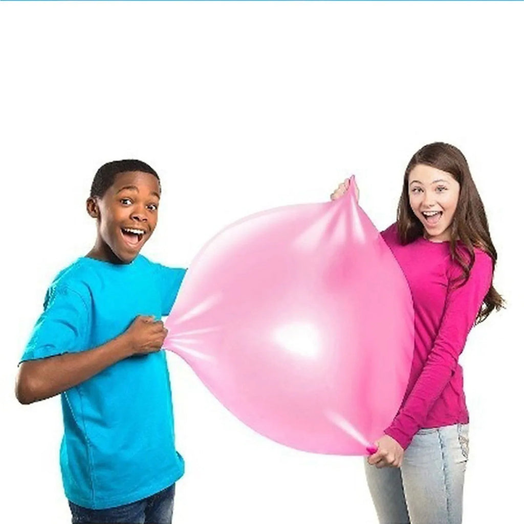 Assortment of inflated pink, yellow, blue and green TPR bouncy balls in different sizes on a plain background.