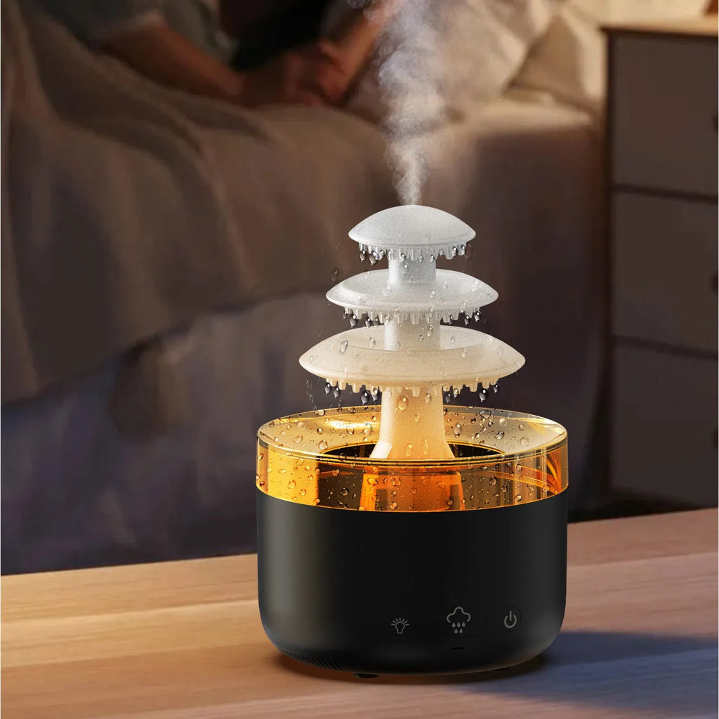 White Cloud Rain air humidifier and essential oil diffuser with colourful LED light on a table.