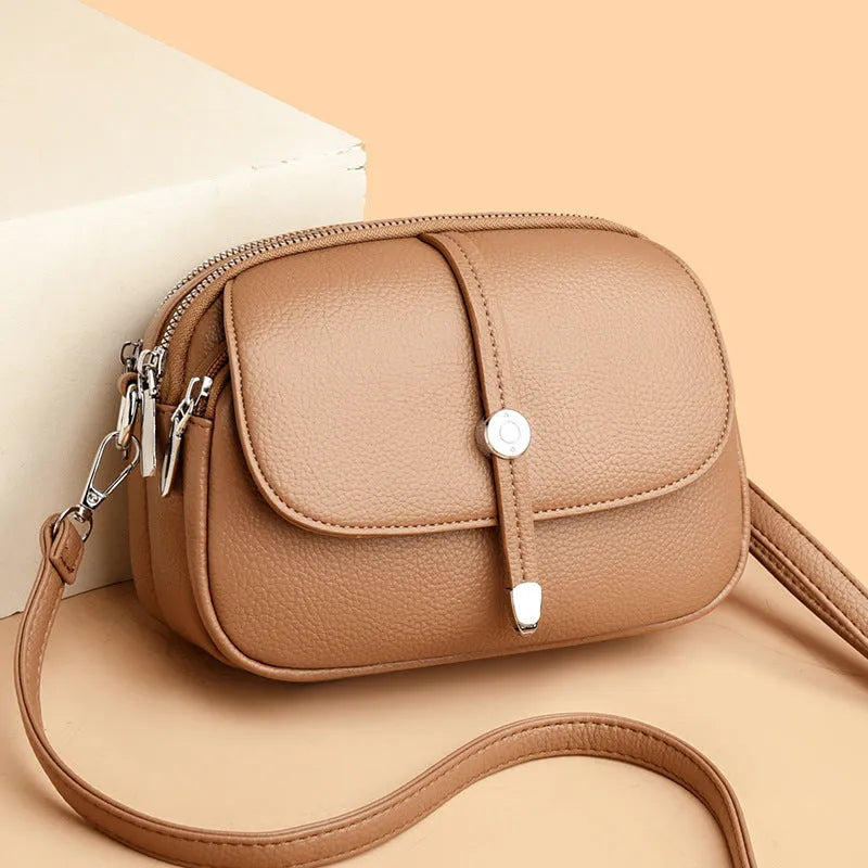 Women's soft PU crossbody shoulder bag with oval suitcase shape in black, khaki, or dark brown