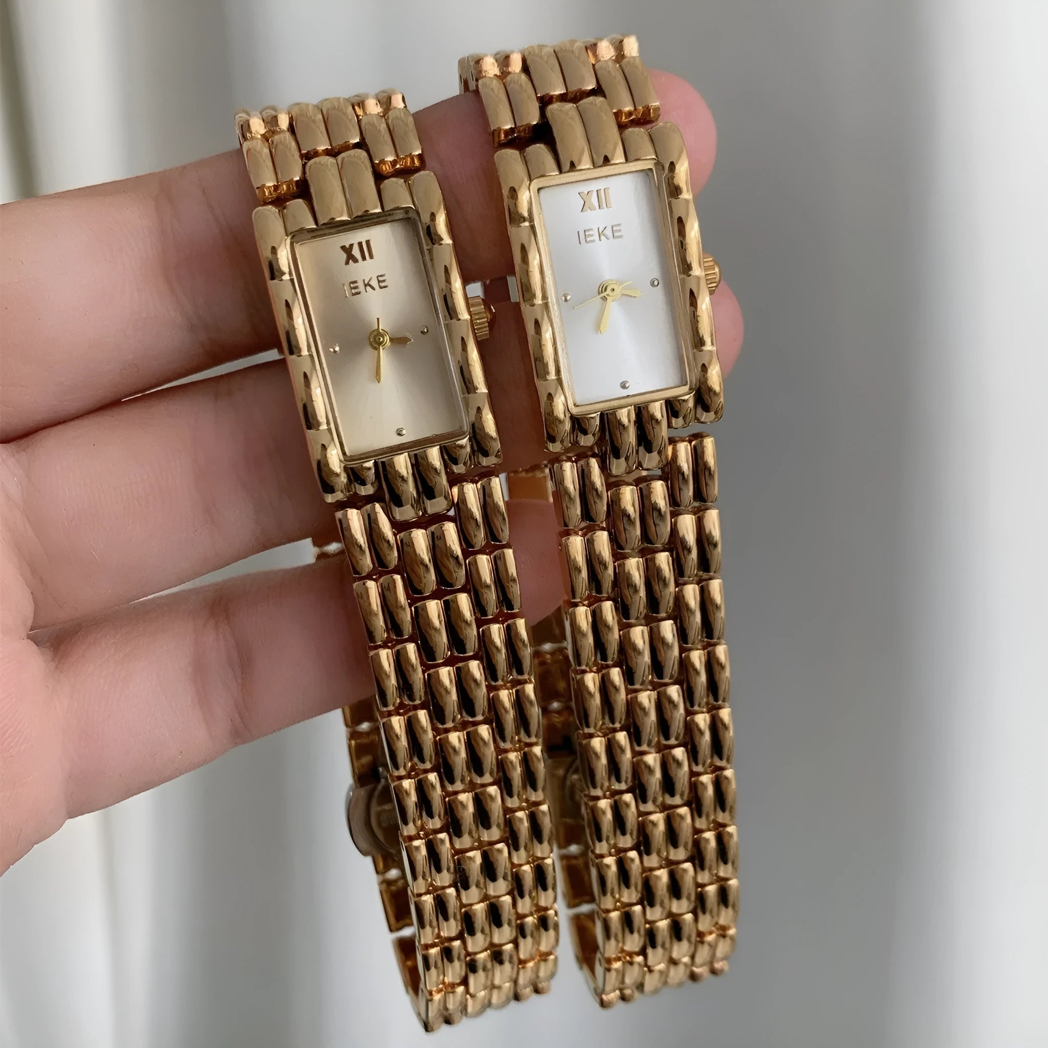 Women's silver and gold mid-ancient bracelet watch with 15mm dial and butterfly clasp.