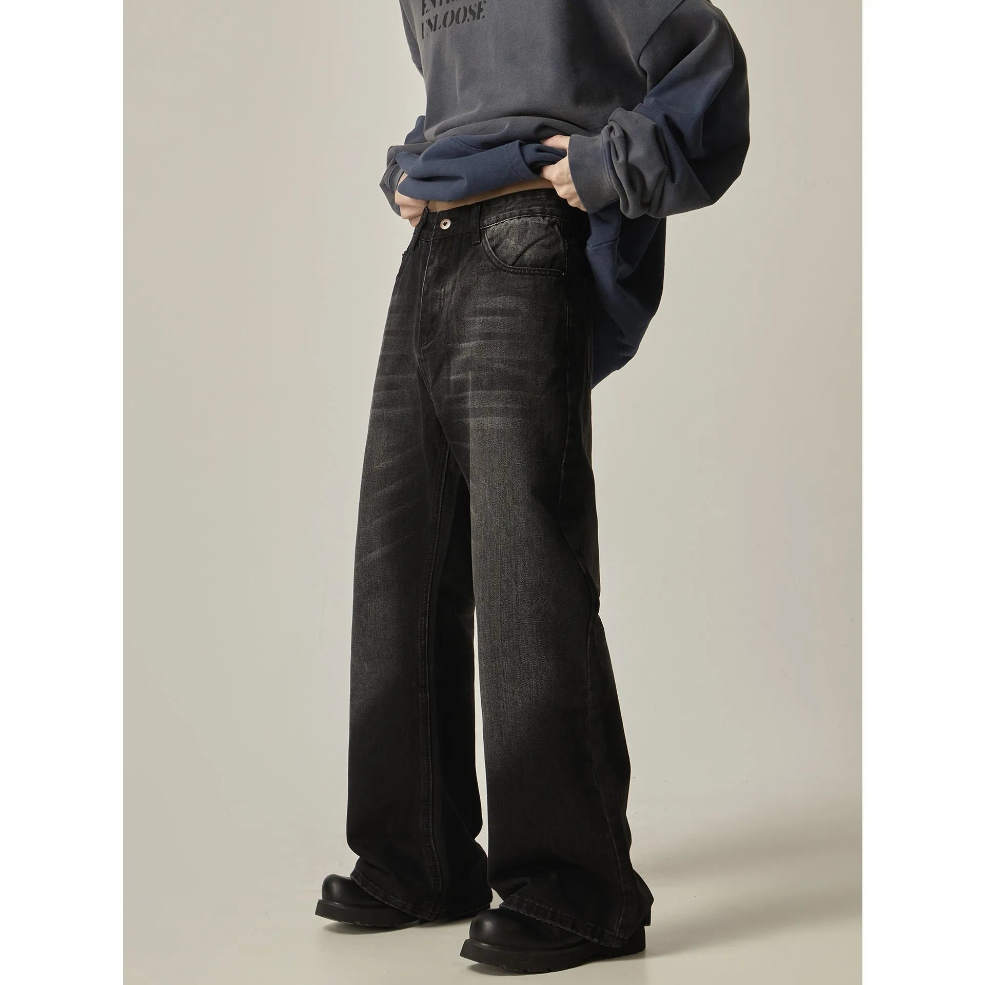 Black American retro loose straight jeans with zip fly opening on denim background