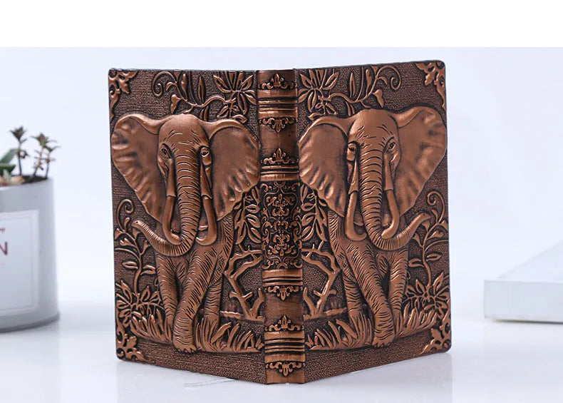 Hardcover PU leather notebook with embossed retro cover and brushed bronze details, open at 180 degrees showing beige pages