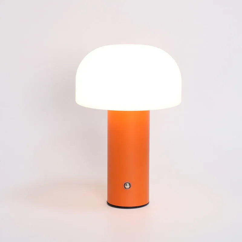 White plastic USB table lamp with integrated charging port on a wooden desk.