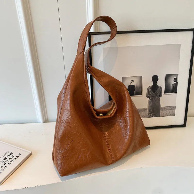 Soft leather large capacity casual shoulder bag with zip closure in multiple colour options.