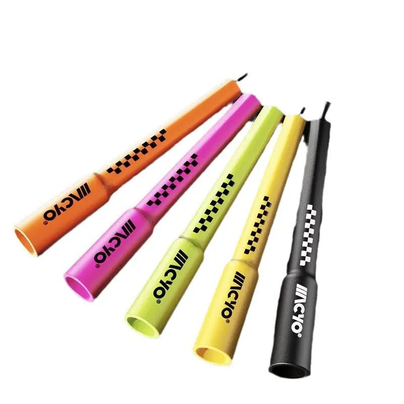 Colourful PVC fitness skipping rope for physical exercise on a plain background