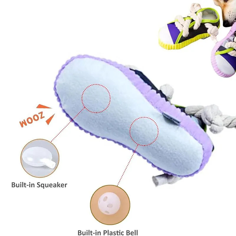 Grey and white dog toy slipper with black laces, blue sole, and a bell on the side