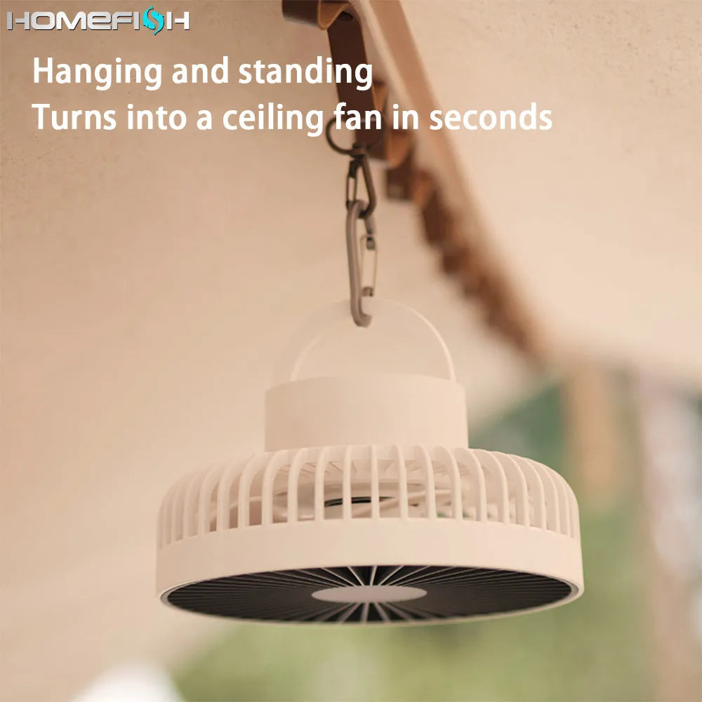 White tripod camping fan on a desk, with USB cable and adjustable speed dial