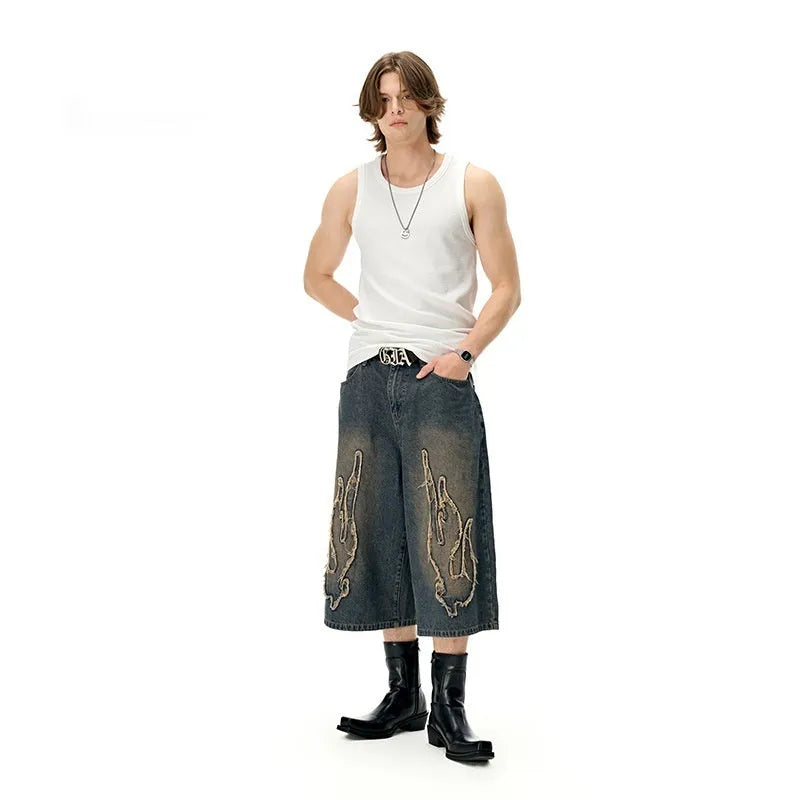 Men's black denim shorts with cropped patch flame embroidery detail, straight leg cut