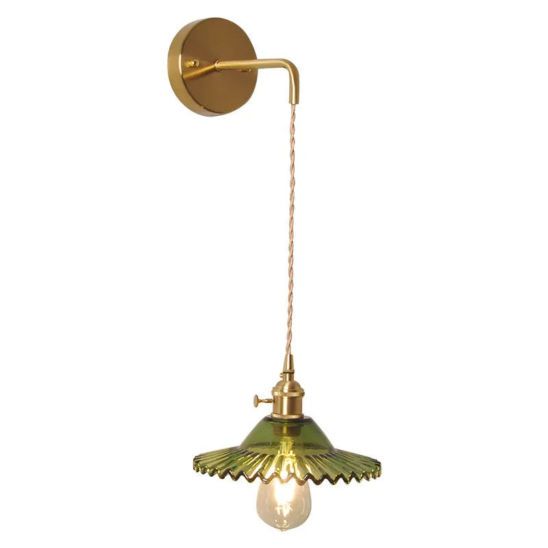 Retro brass lotus wall lamp with adjustable copper wire and white glass shade mounted on a wall.