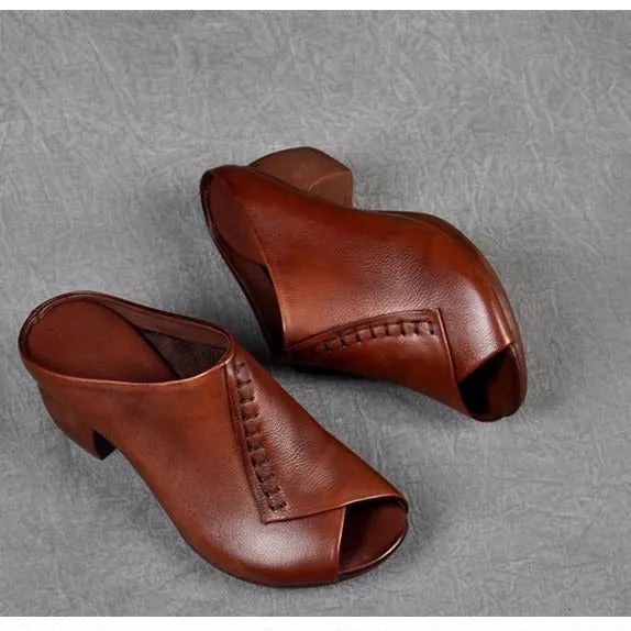 Women's black square heel peep-toe slippers with a fish-mouth scaffold design on a white background.