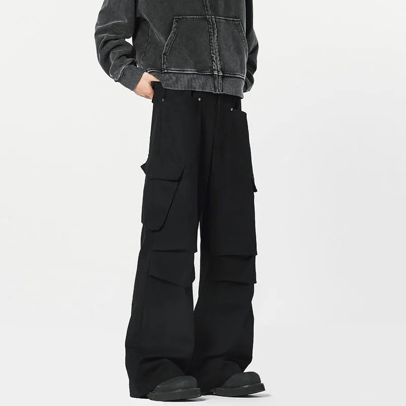Man wearing retro style high-waisted straight leg casual trousers in black.