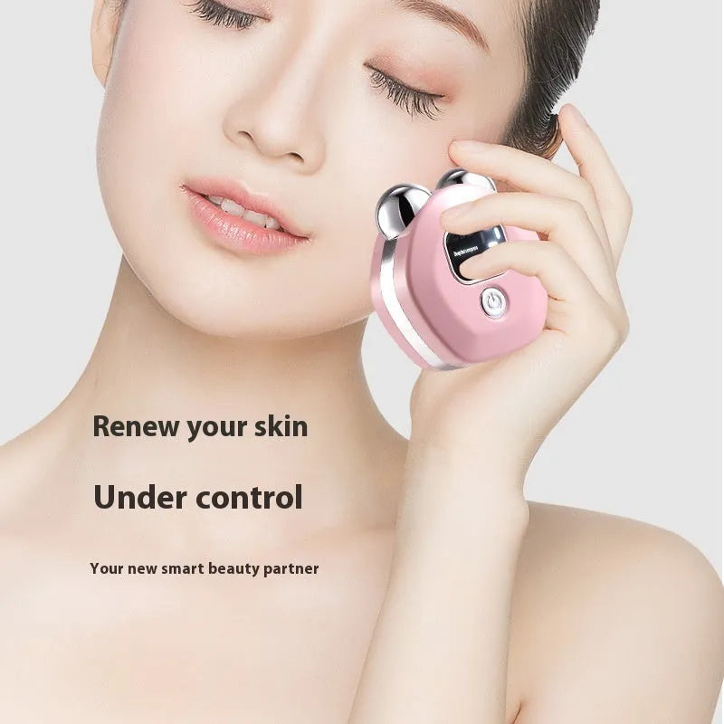Portable white microcurrent facial massager with dual rollers and charging cable.