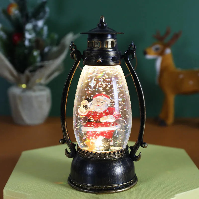 Clear plastic crystal ball LED portable oil lamp with a decorative snowman figure inside on a table.