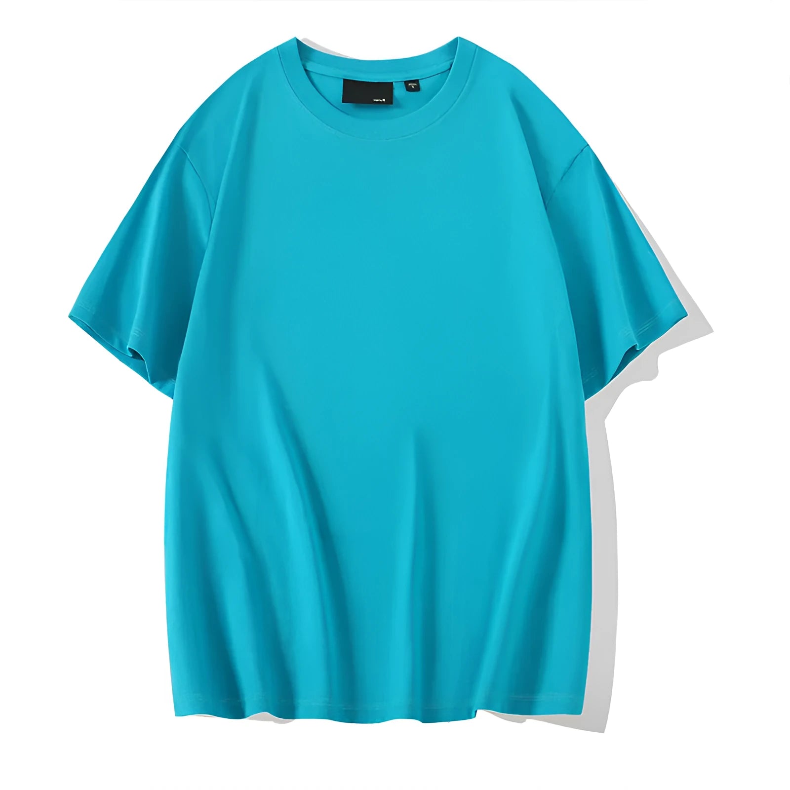 Man wearing a loose-fitting solid colour cotton t-shirt with drop-shoulder sleeves.